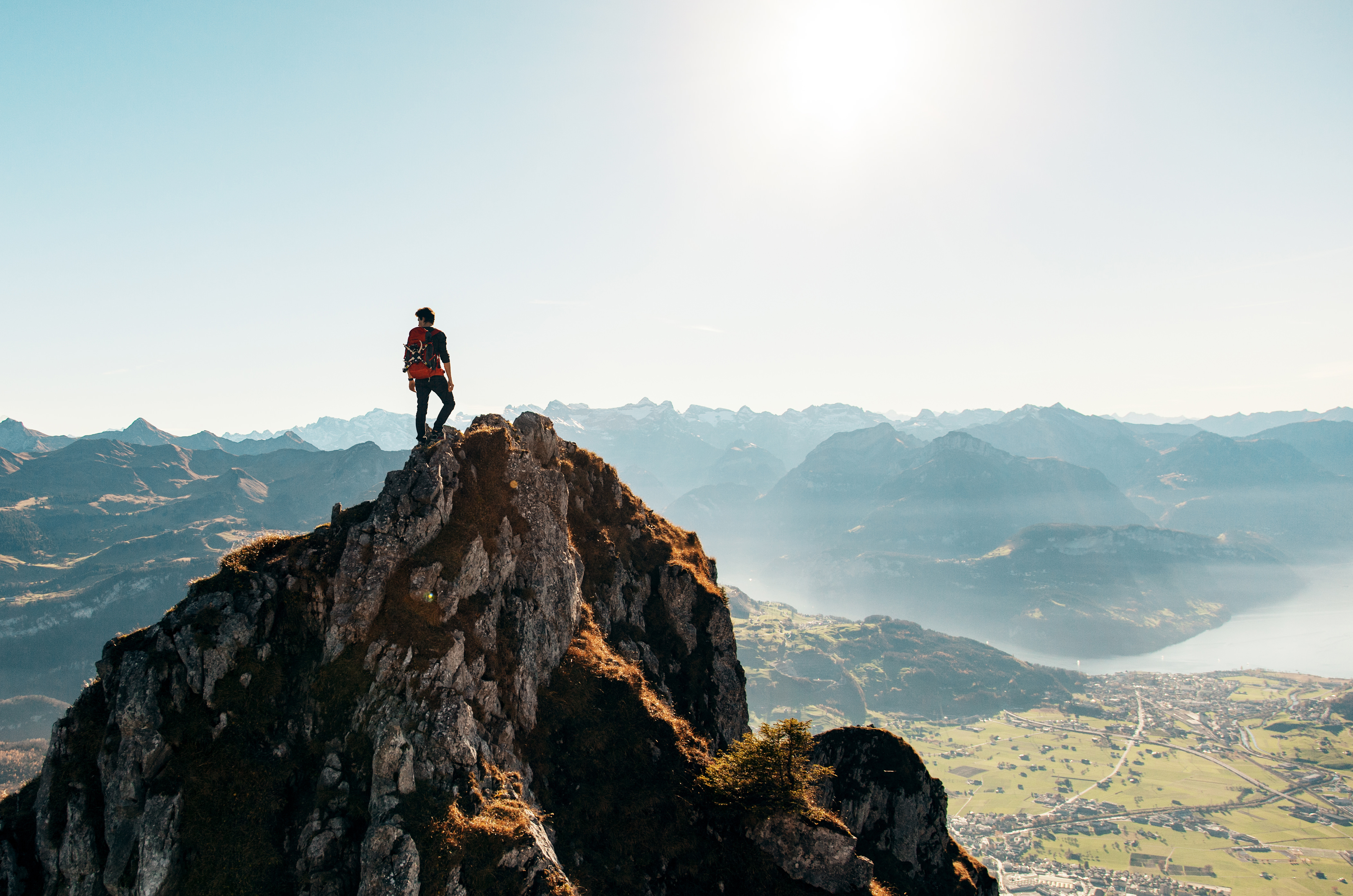 Man standing on mountain. Represents pushing yourself to the right amount